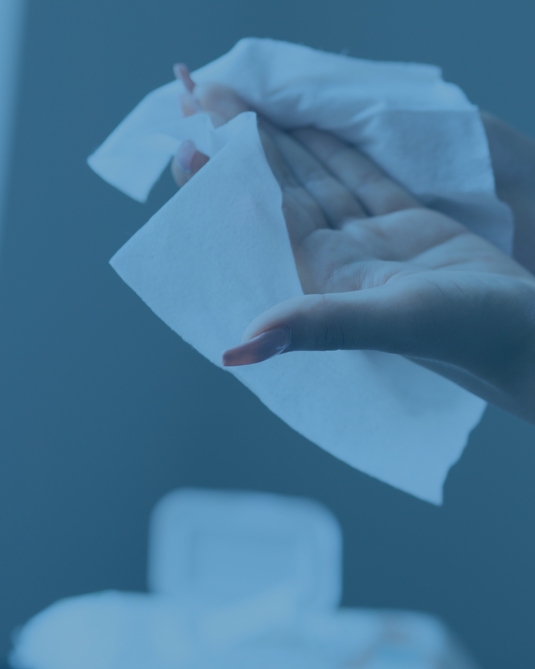 Person cleaning hands with moisturizing sanitizing wipes  