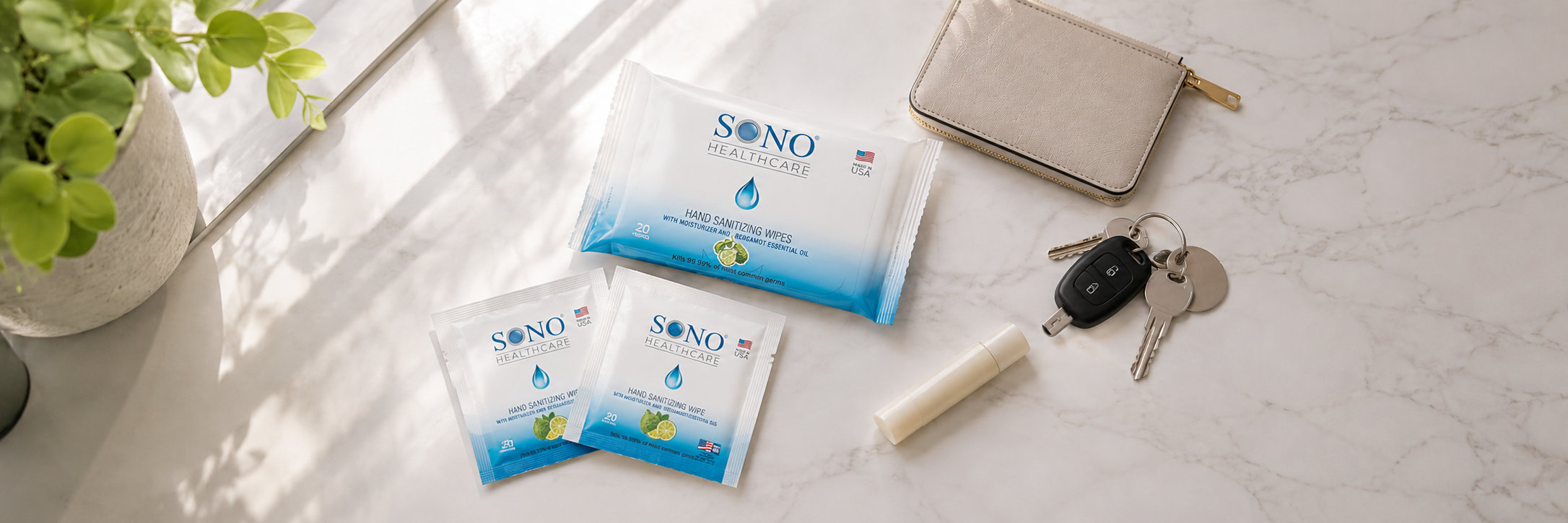 Sono hand wipe packets on a light surface with keys and a wallet