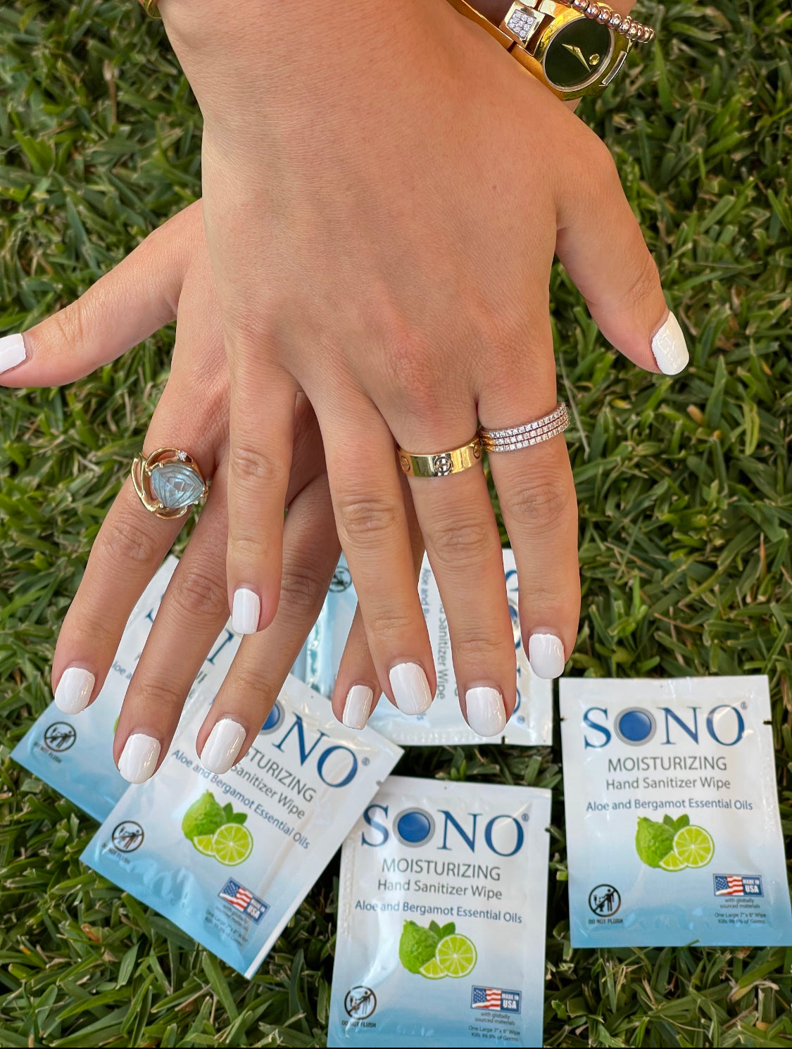 Hand holding SONO hand wipes wipes on grass