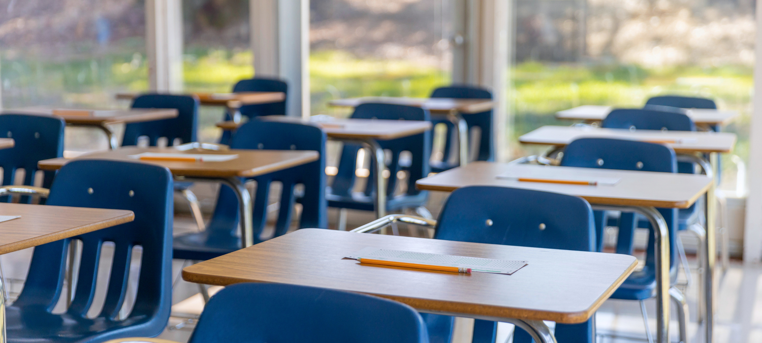 Empty classroom with desks and chairs