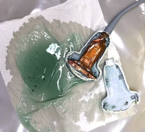 Electrode with green gel on a white surface